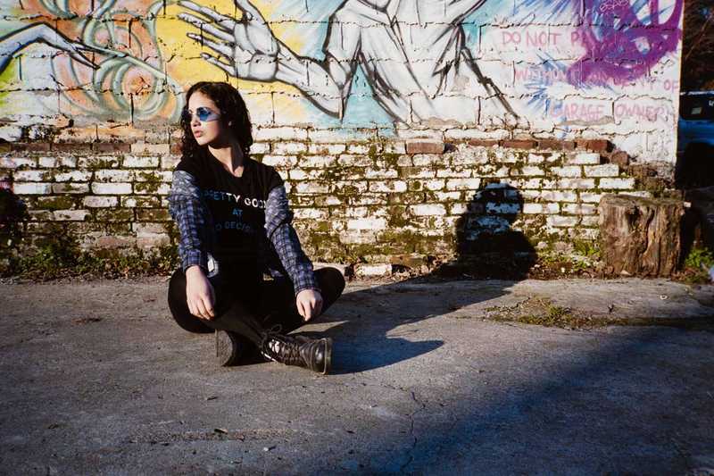 Girl posing in front of some street art outside