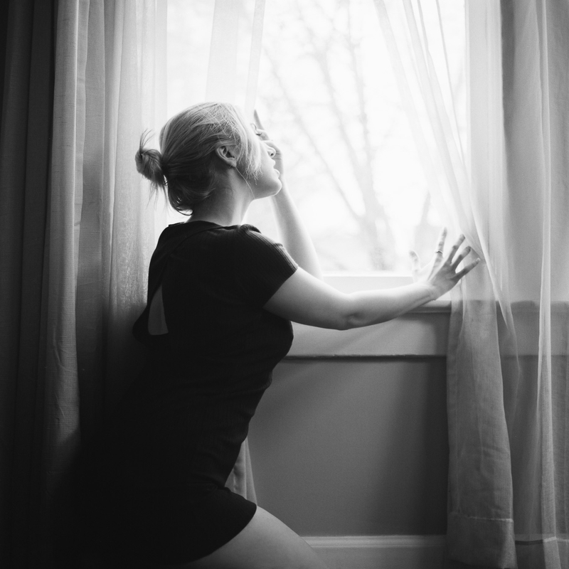 Model posing in front of a window