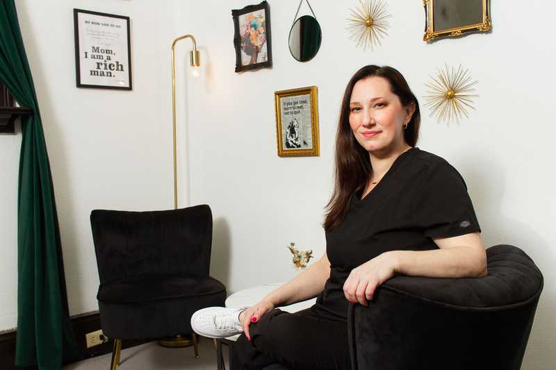 Personal branding portrait of Portland esthetician Kate sitting in the client lounge area