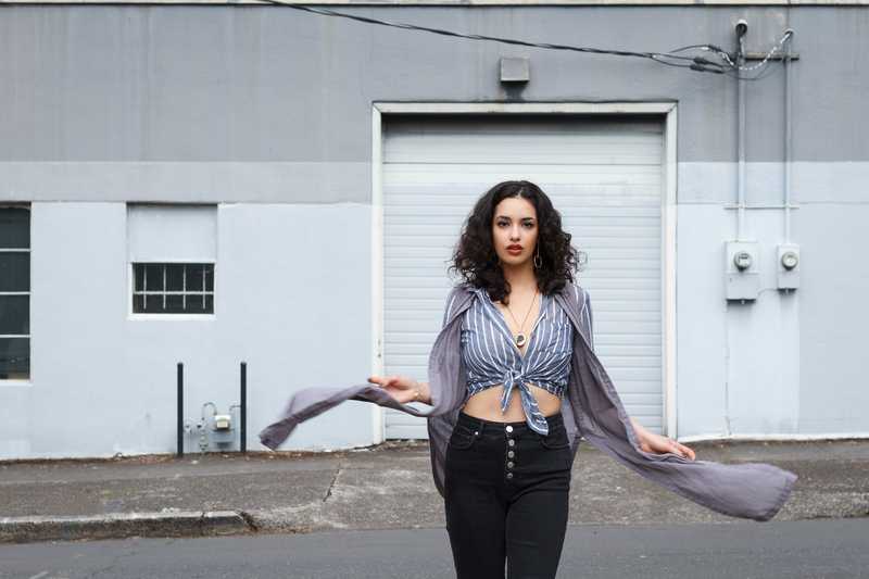 Model posing in front of an industrial building