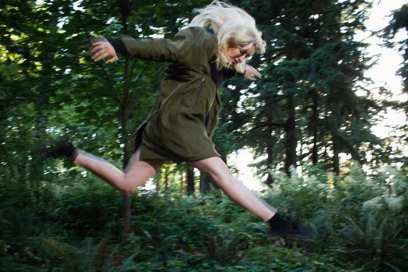 Jumping in the air in a forested section of the park