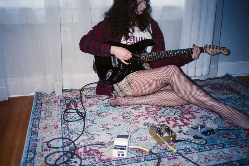 Grungy image of a girl guitar player