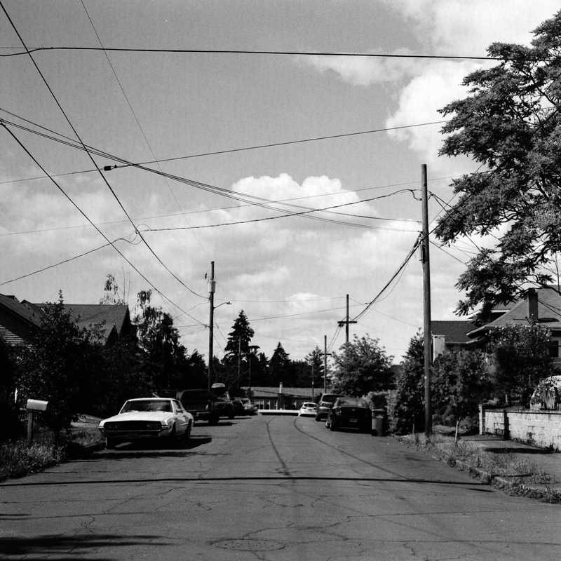Neighborhood scene with houses and cars