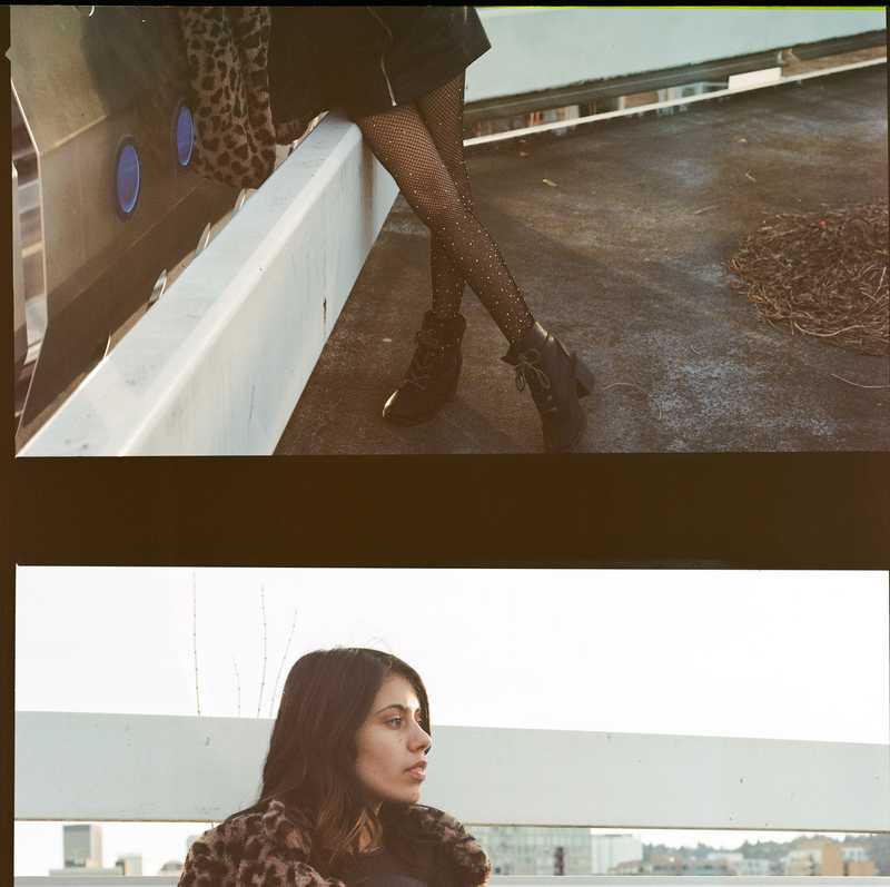 Two cut off film frames of a model posing at a parking garage in NW Portland, OR